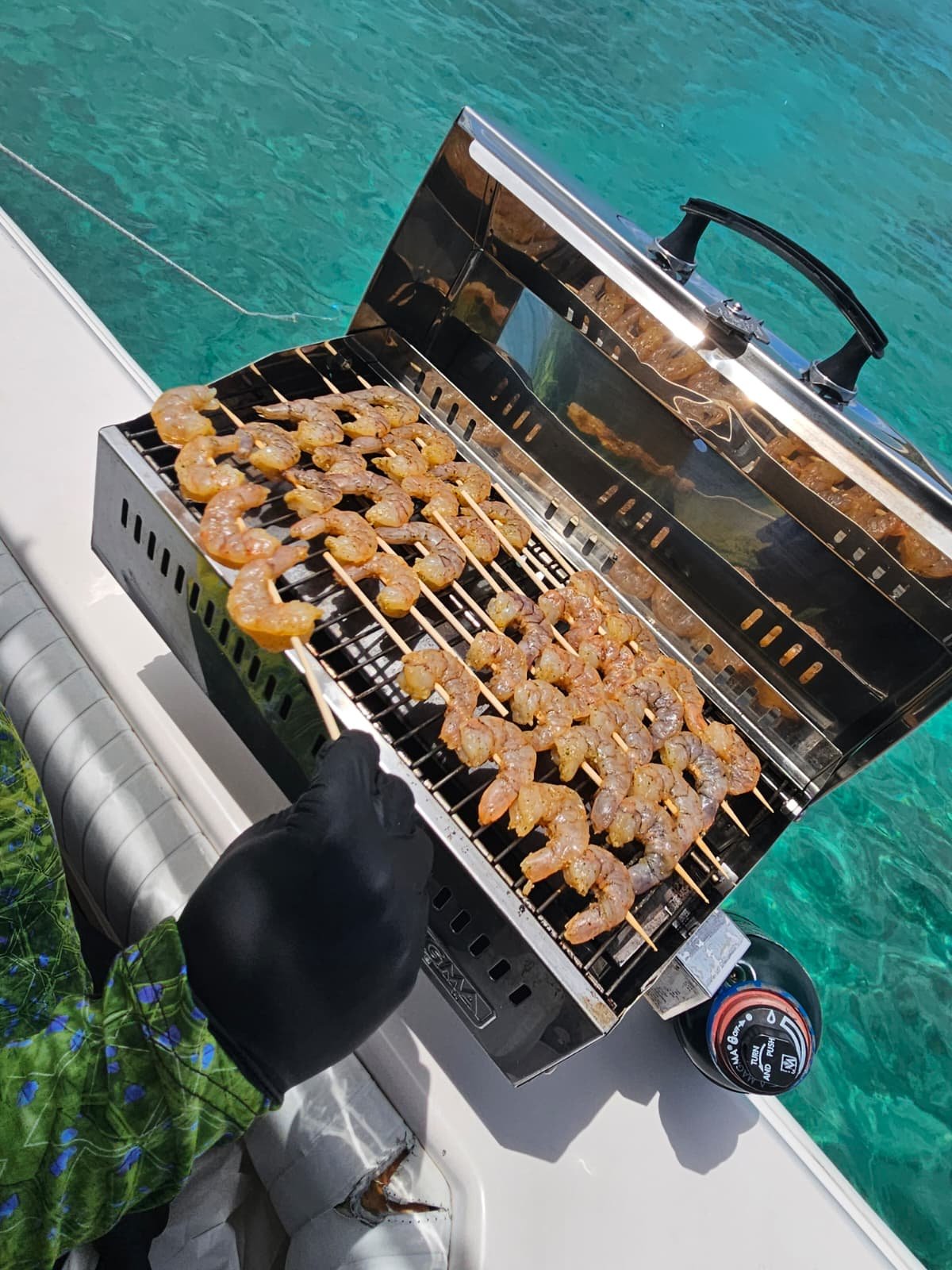 Fresh shrimp skewers and grilled chicken plated on the boat over turquoise Caribbean water — Boating Puerto Rico onboard BBQ