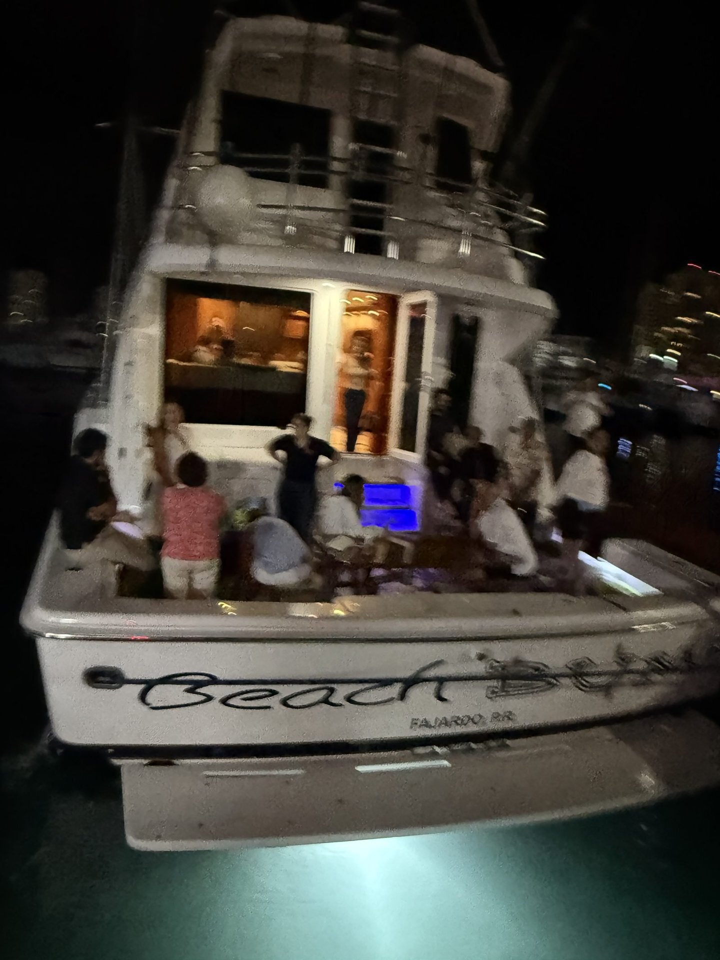 Bertram 70ft stern lit up at night for a private celebration