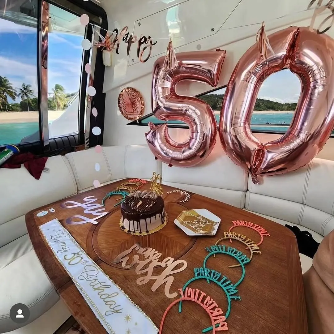 50th birthday rose gold decorations and cake onboard