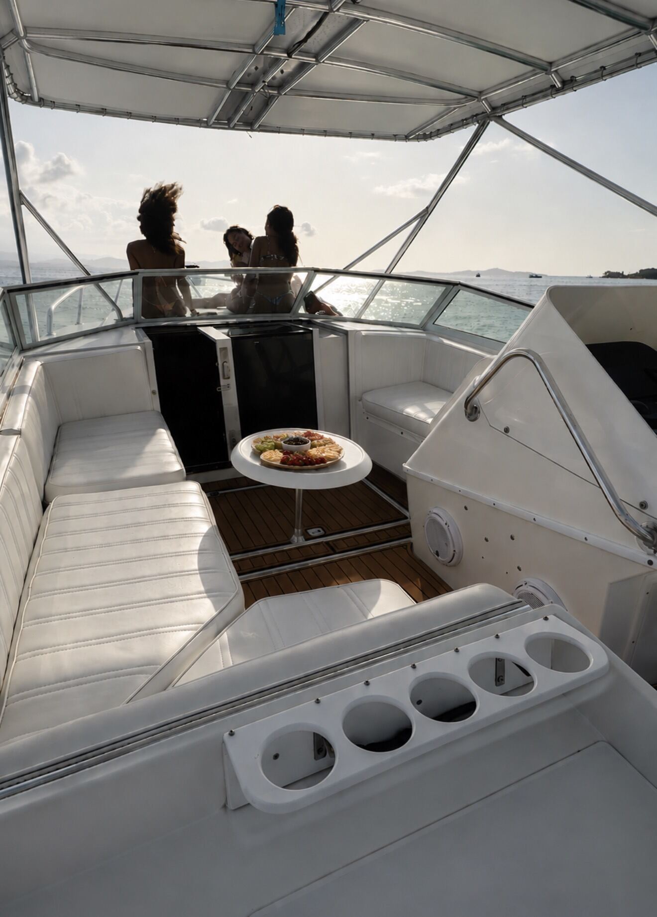 Guests on the bow of the Contender 38 at sunset with a picada board on the cockpit table, Fajardo Puerto Rico