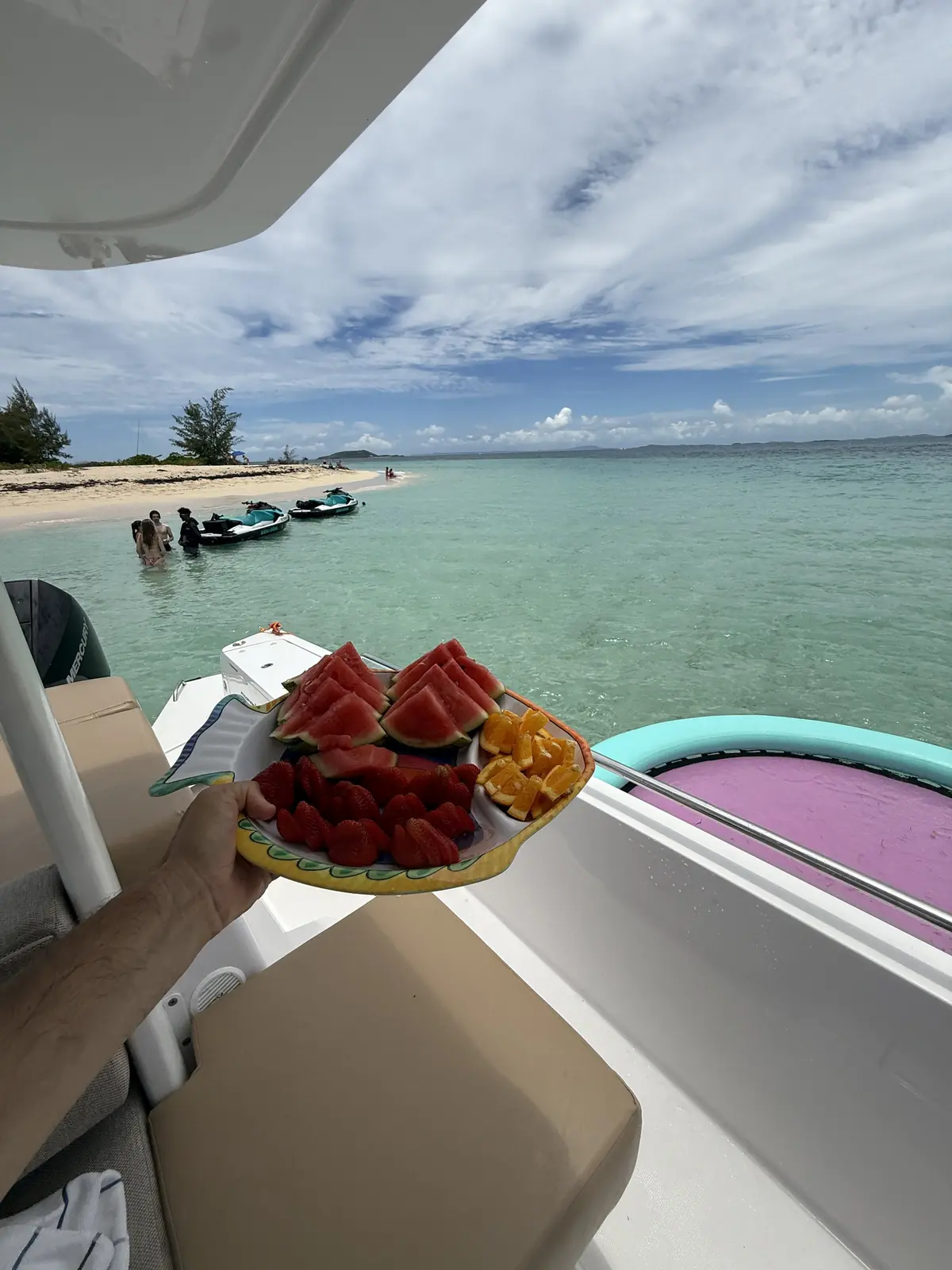 Fresh fruit platter served on yacht — watermelon, strawberries, oranges