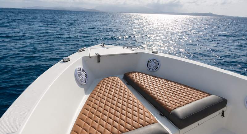 View forward over the cushioned bow of the Hydra Sport 25 towards open Caribbean water and afternoon sun off the coast of Puerto Rico