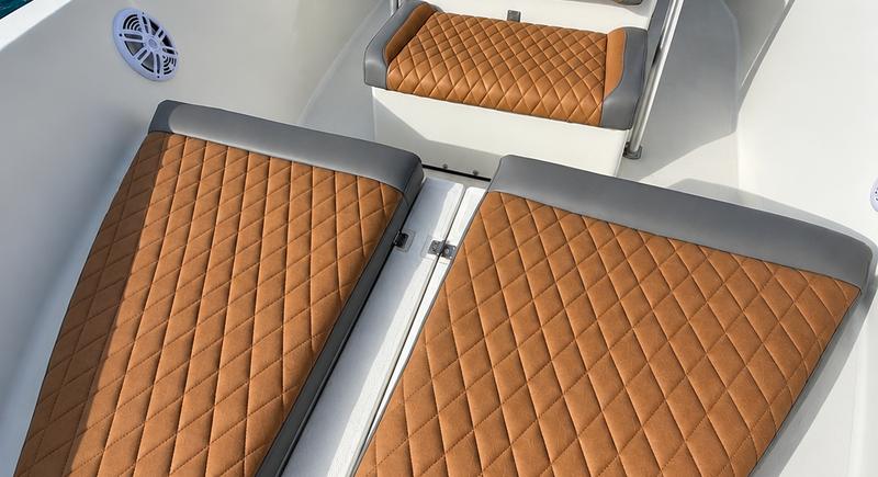Padded bow lounge of the Hydra Sport 25 seen from above, cushions laid flat across the forward deck while moored at Marina Puerto del Rey