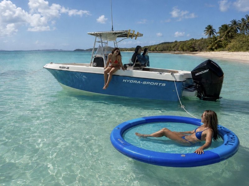Hydra Sport 25 center console anchored off a palm-lined beach near Fajardo, Puerto Rico, with guests on board and on the floating mat