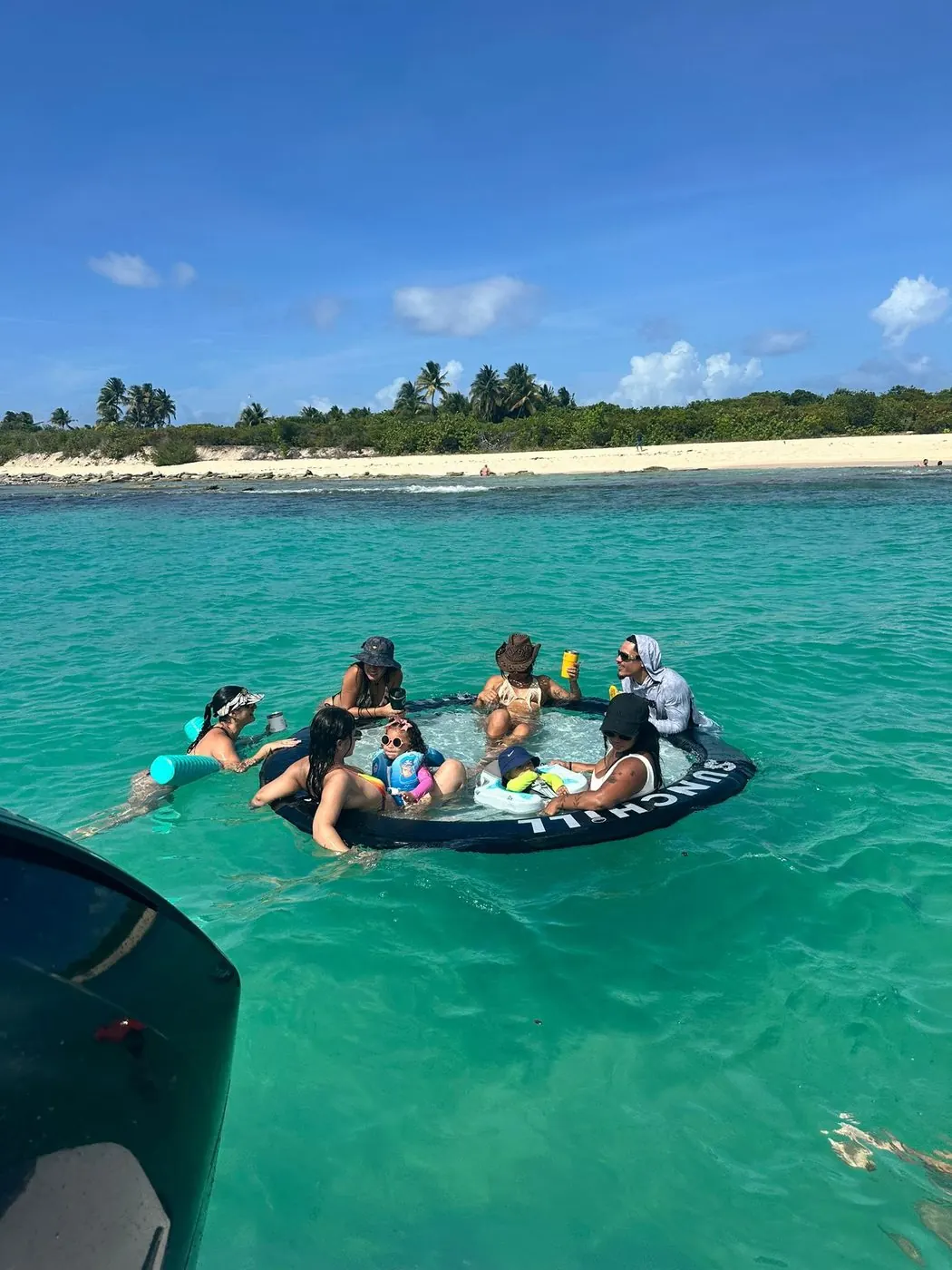 Guests on the floating mat beside the Axopar
