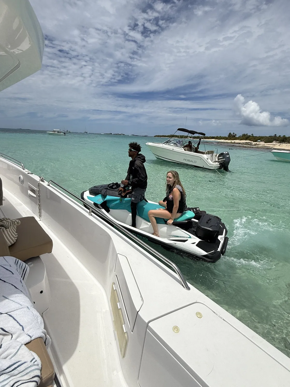 Sea-Doo jet ski tied to yacht with guests — delivered directly to your charter at the sandbar